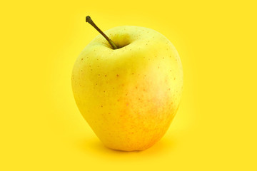 yellow apple on a yellow background