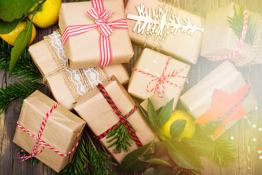 Many decorated Christmas presents on wooden background