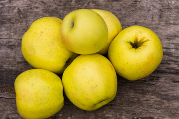 Ripe green apples on rustic wooden table
