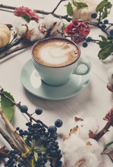 Pumpkin spice latte. Coffee cup on white wood background © Prostock-studio