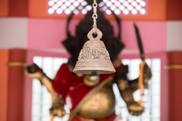 Metal bell hanging with lard ganesha  statue background