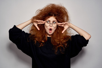 shaggy girl with glasses with hands on her face fooling around