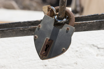Rusty metal padlock on the railing. Lock as a symbol of love