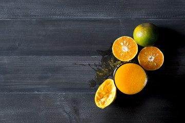 Orange juice on dark wood.
