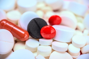 red pills background of white medicinal tablets