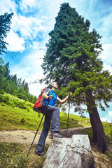 Hiking in the mountains in the summer with a backpack.