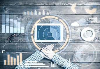 Business workplace with tablet device coffee cup and media graph