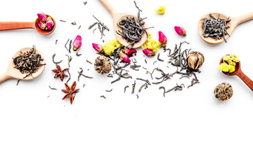 Dried tea leaves near supplements like flowers and spices on white background top view pattern copyspace