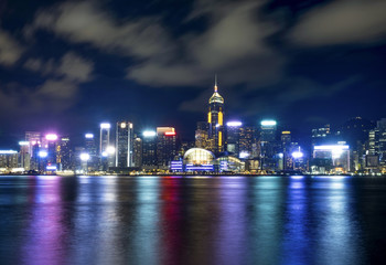 Hong Kong night building skyline with motion clouds and reflection of light
