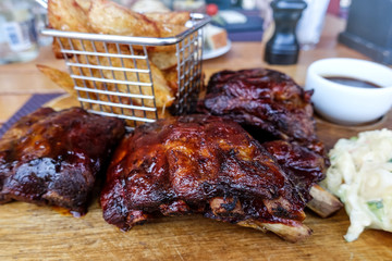 Grilled steak - Grilled meat ribs on the plate with hot sauce