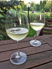 wine glasses on a wooden table at garden
