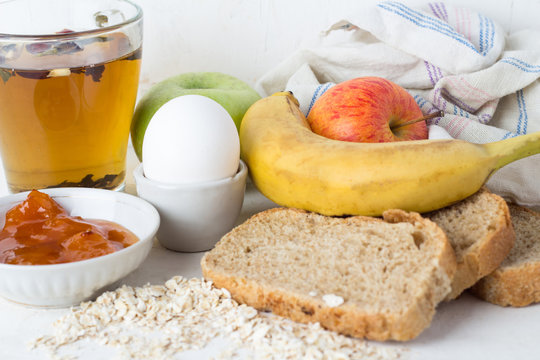 concept of healthy breakfast, tea, bread, oatmeal, eggs and fruits.
