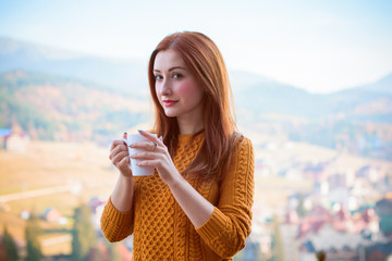 Beautiful and harmonious morning on vacation in the mountains. A girl enjoying a day off with a cup of coffee. Beautiful landscapes and views for relaxing the soul and body. A healthy lifestyle