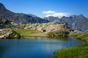 Mountain lake of Vej del Bouc with a shepherd hut, trip in the Maritime Alps National Park (Piedmont, Italy)