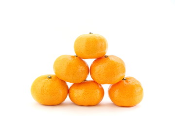 Pile of many orange fruits on white background, side view