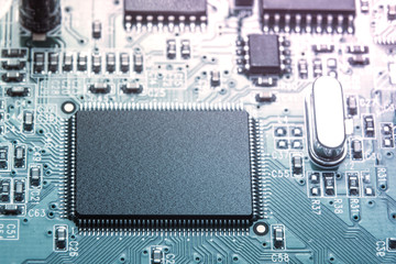 Close-up of green toned electronic computer chip on motherboard