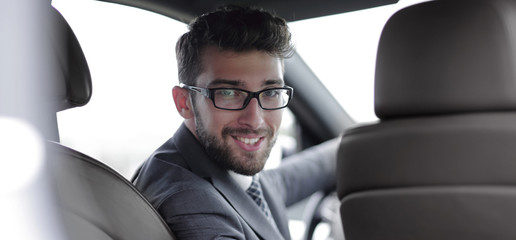 Fototapeta na wymiar man in formalwear sitting in car