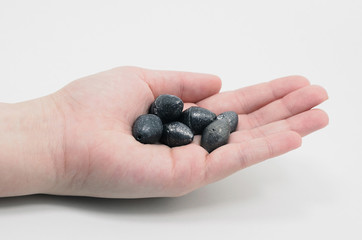 Hand holding a lead weight sinker used to sink lines for fishing.