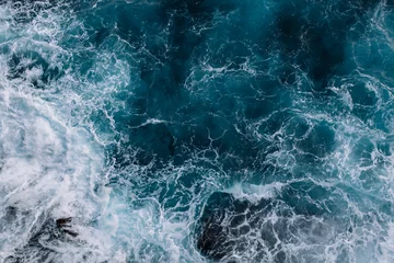 Tuinposter Aerial view to ocean waves. Blue water background © Ivan Kurmyshov