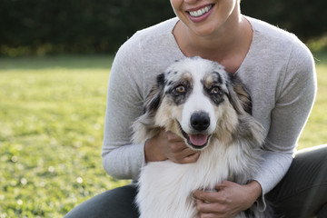 Beautiful woman and her dog posing together
