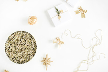 Christmas gifts, golden baubles, stars, garland on white background. Flat lay, top view New Year holiday concept.