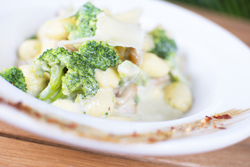Nice stuffed meat with tomatoes with gnocchi. White cream topping with the touch of green seasoning. Beautifully served plate at the restaurant.
