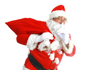 Real Santa Claus carrying big bag full of gifts, isolated on white background
