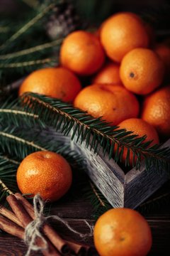 Tangerines with christmas decoration on rustic wooden background. Tangerines with spruce. Christmas decoration