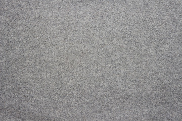 Gray background of woolen textured cloth fabric.