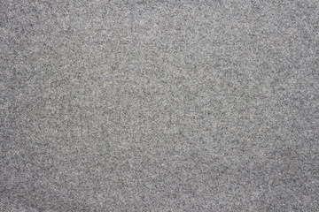 Gray background of woolen textured cloth fabric.