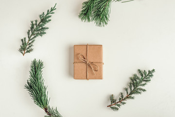 Fototapeta na wymiar gift, a surprise in the box is packed in brown vintage paper and tied with a rope, scoop. Christmas concept. on a white homogeneous background. near a branch of a coniferous tree