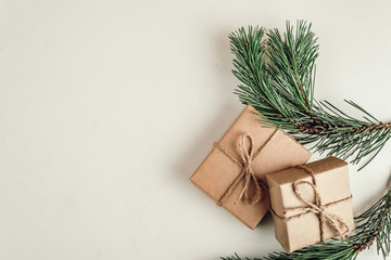 gift, a surprise in the box is packed in brown vintage paper and tied with a rope, scoop. Christmas concept. on a white homogeneous background. near a branch of a coniferous tree