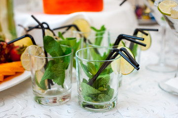 mohito and fresh fruits and berries of bright colors cut in small pieces served in restourant