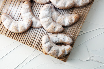 Vanille Kipferl cookies for christmas on brown wood with sugar.