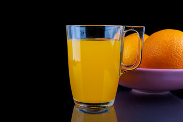 Orange juice -  glass with oranges on black background