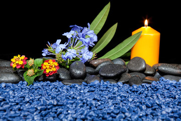 Spa decoration with stones and candles  on a black background