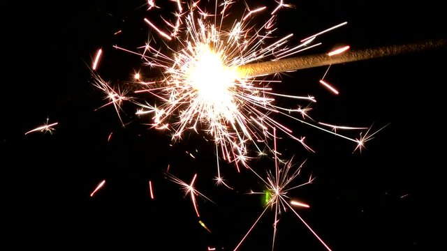 The Sparkler up close and enchanting lights. Lights sparked and burned in his hands. Festive sparklers close - an attribute of good mood. 