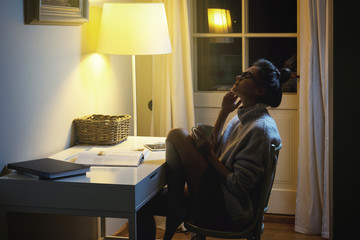 Woman wearing a warm woolen sweater is reading book