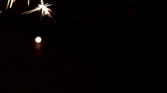 The Sparkler up close and bright. Lights sparked and burned in his hands. Festive sparklers close - an attribute of good mood.