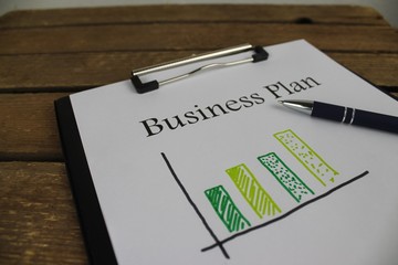  Cover page of a business plan with a pen from the bottom right