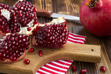 Pomegranate on the wooden cutting board