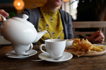 Woman pouring green tea