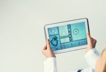 Close of female doctor hands working with tablet pc computer