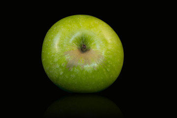 green granny smith apple on black background isolated