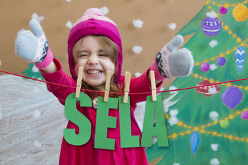 sale, christmas, holidays and people concept - smiling baby in red dress with sale sign