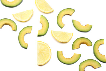 healthy food. sliced avocado with lemon isolated on white background. top view