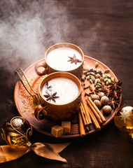 Masala tea chai latte traditional hot Indian teatime ceremony sweet milk with spices, herbs organic...