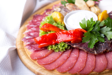 Assorted meat products with sausages and marinated vegetables