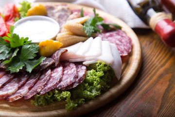 Assorted meat products on wooden board