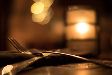 Restaurant Silverware and Candle Bokeh 